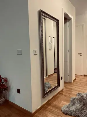 a mirror on a wall in a living room at Apartman Stojić in Banja Luka