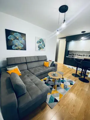 a living room with a couch and a piano at Apartman Stojić in Banja Luka