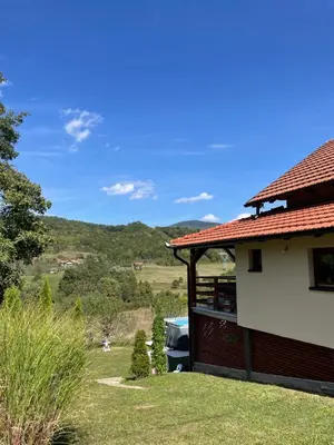 a house with a car parked next to it at Vikendica Krupa in Banja Luka