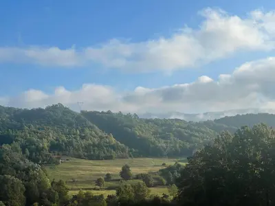 a view of a field with trees on a hill at Vikendica Krupa in Banja Luka