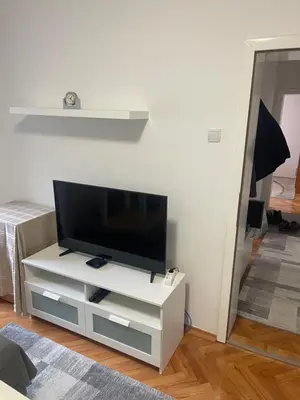 a flat screen tv sitting on a white entertainment center at Apartman IN in Banja Luka