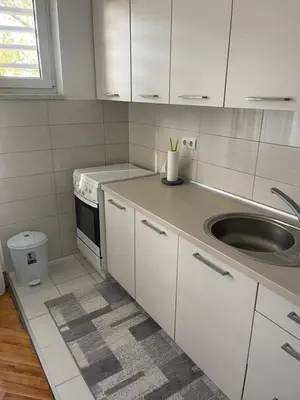a kitchen with white cabinets and a sink at Apartman IN in Banja Luka