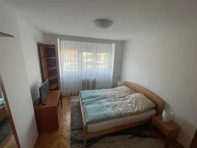 a small bedroom with a bed and a television at Apartman IN in Banja Luka