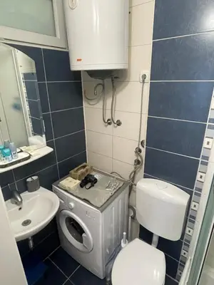 a small bathroom with a toilet and a sink at Apartman IN in Banja Luka