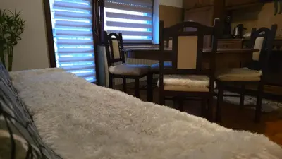 a bedroom with a bed and chairs and a table at Evergreen in Banja Luka