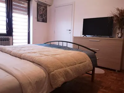 a bedroom with a bed and a flat screen tv at Evergreen in Banja Luka