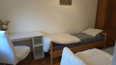 a small room with a desk and a bed at Evergreen in Banja Luka