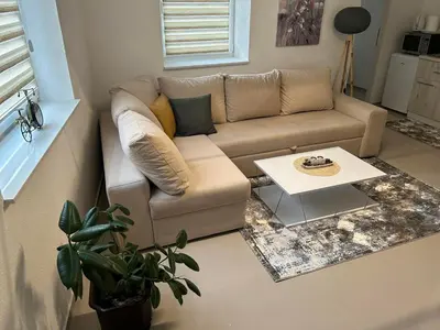 a living room with a couch and a table at Apartman Magus in Tuzla
