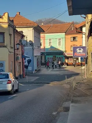 a city street with people walking down the street at Apartman Magus in Tuzla