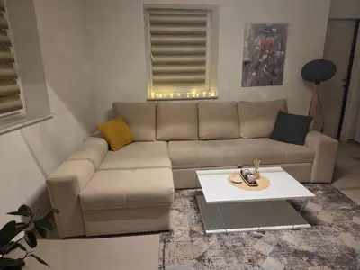 a living room with a couch and a table at Apartman Magus in Tuzla