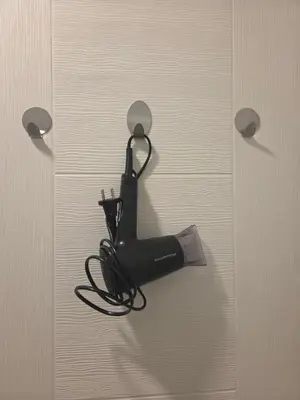a black appliance is hanging on a door at Apartman Magus in Tuzla