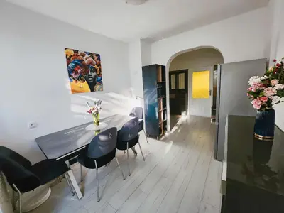 a kitchen and dining room with a table and chairs at Apartman TaMaRa in Doboj