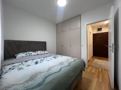 a bedroom with a large bed and a closet at Romanijska in Banja Luka