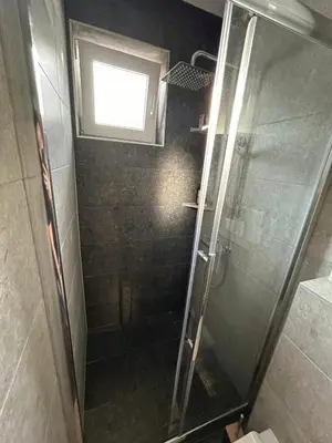 a shower stall with a window in a bathroom at Rosa Canina Kupres 2 - Centar in Kupres