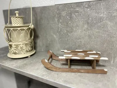 a wooden sled sitting on a table next to a vase at Rosa Canina Kupres 2 - Centar in Kupres