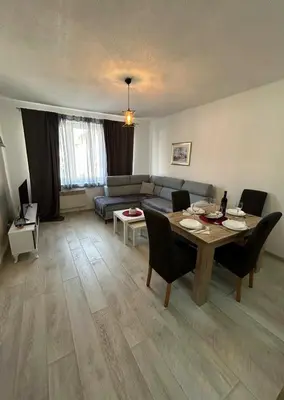 a living room with a table and a couch at Rosa Canina Kupres 2 - Centar in Kupres