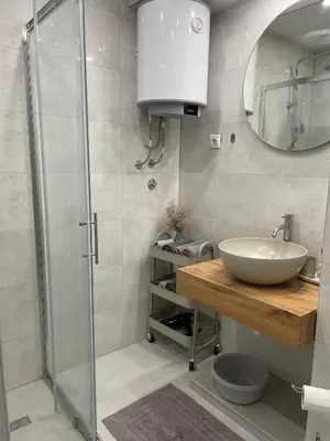 a bathroom with a sink and a shower at Apartman Rita in Livno
