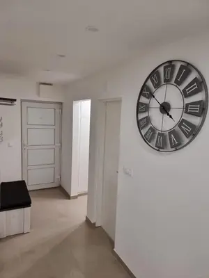 a large clock on a wall in a room at Apartman Rita in Livno