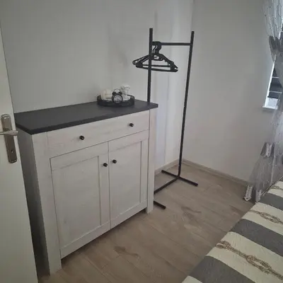 a white cabinet with a black top in a bedroom at Apartman Rita in Livno