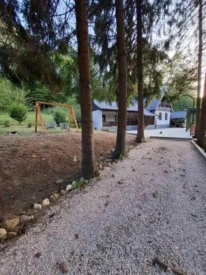 a park with a playground with trees and a house at Vikendica Tuzla, Dolina mira in Tuzla