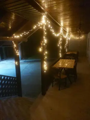 a lit up room with a table and lights at Vikendica Tuzla, Dolina mira in Tuzla