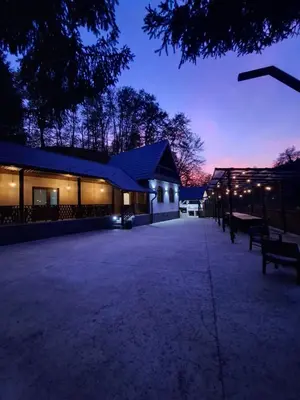 a building with a parking lot at night at Vikendica Tuzla, Dolina mira in Tuzla