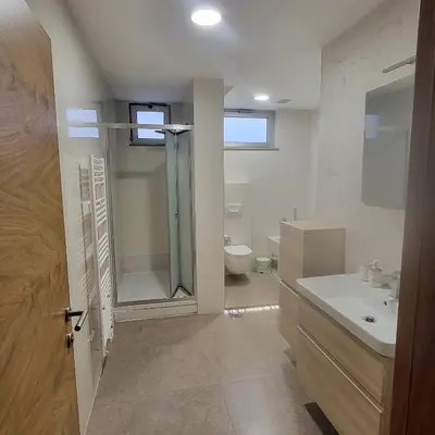 a bathroom with a shower and a sink and a toilet at APARTMAN CENTAR BULEVAR EX sa GARAZOM in Banja Luka