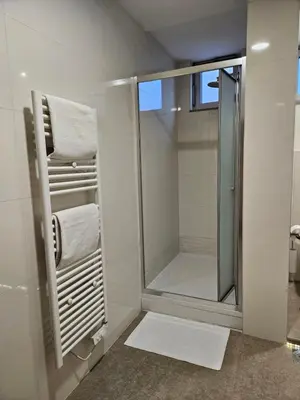 a bathroom with a shower and a glass shower stall at APARTMAN CENTAR BULEVAR EX sa GARAZOM in Banja Luka