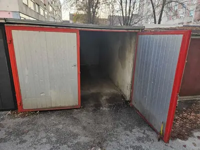 a garage with two doors on the side of it at APARTMAN CENTAR BULEVAR EX sa GARAZOM in Banja Luka