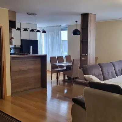 a living room with a couch and a table at APARTMAN CENTAR BULEVAR EX sa GARAZOM in Banja Luka