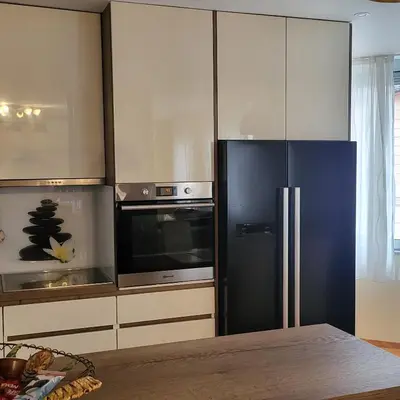 a kitchen with a black refrigerator and a microwave at APARTMAN CENTAR BULEVAR EX sa GARAZOM in Banja Luka