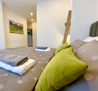 a bedroom with a bed with green pillows on it at Visoravan 1200 in Kupres