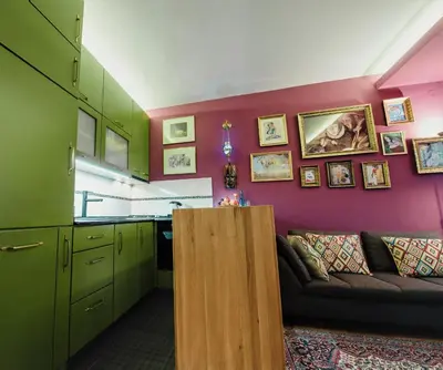 a living room with green cabinets and a couch at Divan Apartman u Banjaluci in Banja Luka