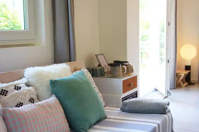 a living room with a couch with pillows on it at Apartment Pirol: Dorf Hideaway Gornja Breza in Breza