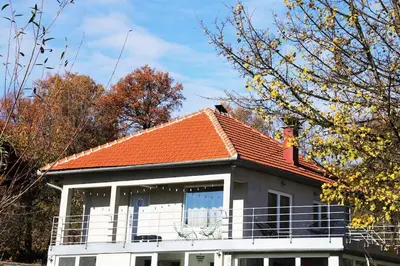 a white house with an orange roof at Apartment Pirol: Dorf Hideaway Gornja Breza in Breza