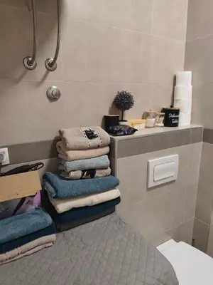 a pile of towels are stacked in a bathroom at Kastel in Banja Luka
