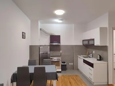 a kitchen with a table and some chairs in it at Kastel in Banja Luka