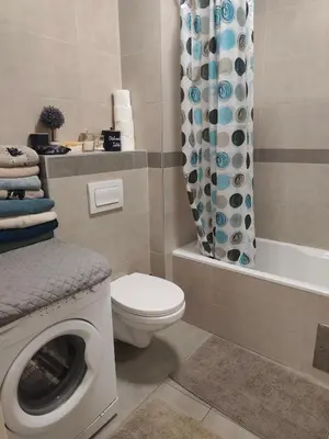 a bathroom with a washing machine and a toilet at Kastel in Banja Luka