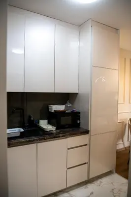 a kitchen with white cabinets and a microwave at Harmony Space Apartment in Banja Luka