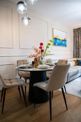 a dining room with a table and chairs and a couch at Harmony Space Apartment in Banja Luka