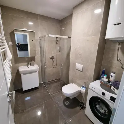 a bathroom with a shower and a toilet and a sink at Harmony Space Apartment in Banja Luka