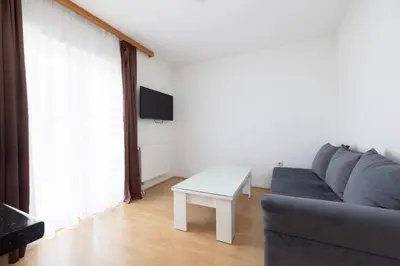 a living room with a couch and a table at Apartman Ana in Kupres