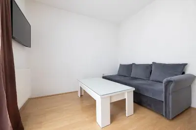 a living room with a couch and a table at Apartman Ana in Kupres