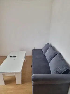 a living room with a couch and a white table at Apartman Ana in Kupres