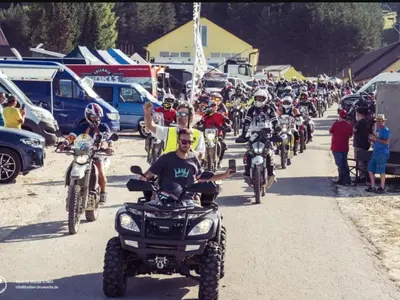 a large group of people riding motorcycles on a dirt road at Apartman Ana in Kupres