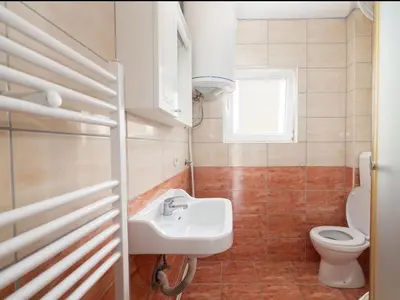 a bathroom with a sink and a toilet at Apartman Ana in Kupres