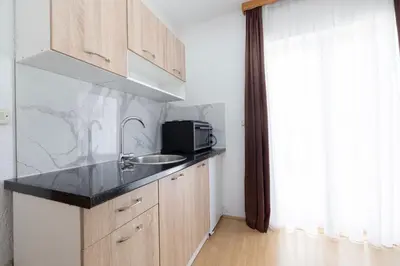 a kitchen with a sink and a microwave at Apartman Ana in Kupres