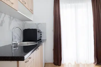 a kitchen with a sink and a window at Apartman Ana in Kupres