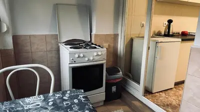 a small kitchen with a stove and a refrigerator at White home apartment in Banja Luka