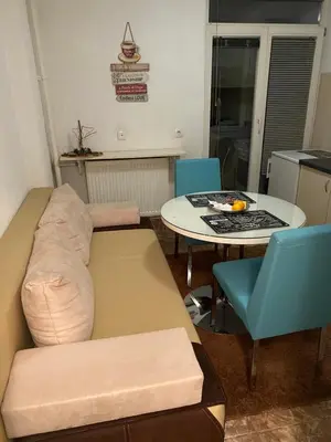 a living room with a couch and a table at White home apartment in Banja Luka